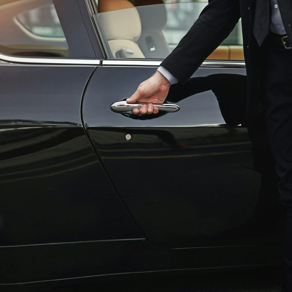 Top class transportation. Cropped shot of a well dressed man opening a car door.